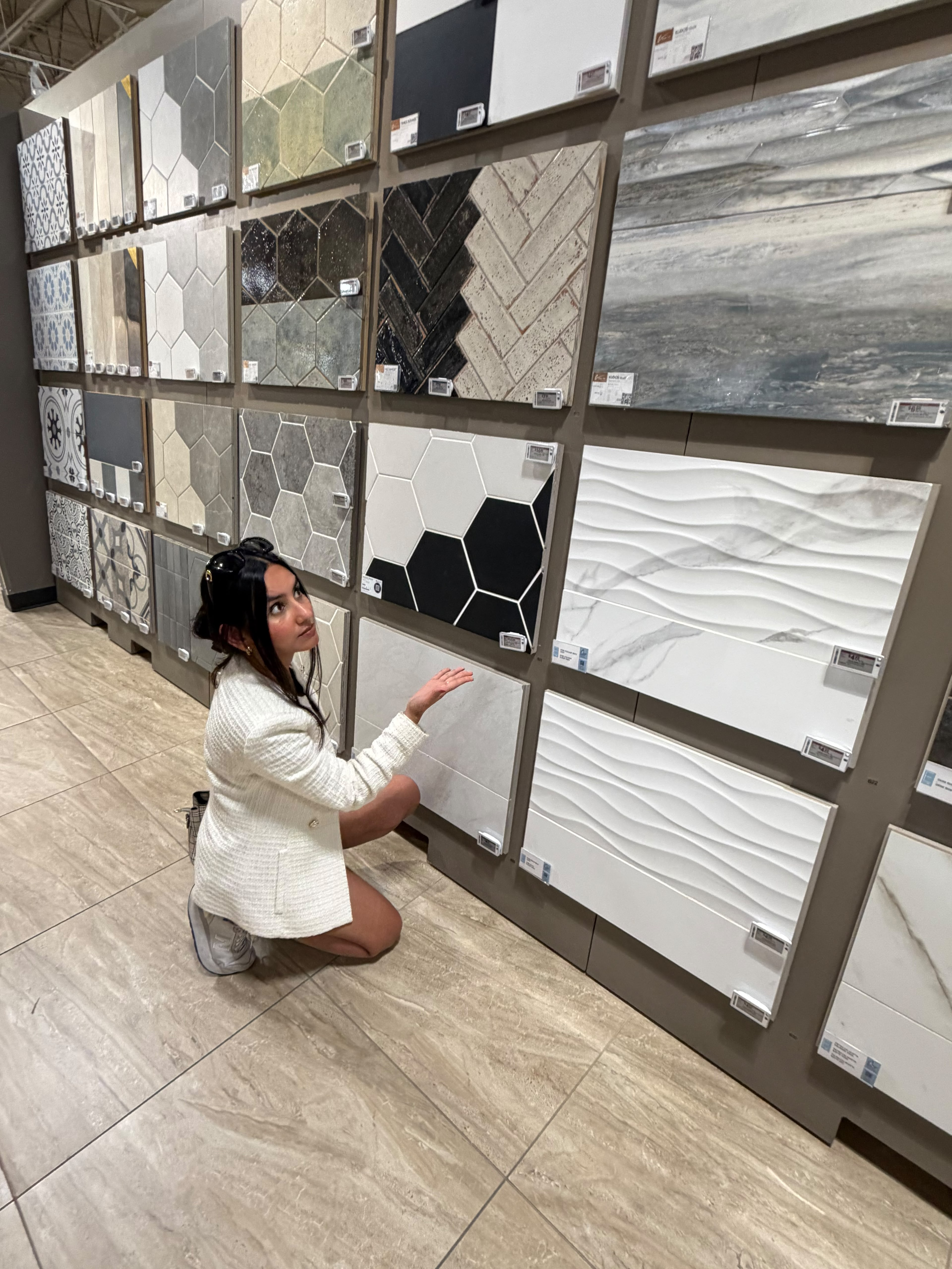Shreya Agarwal exploring wall tile displays in a showroom
